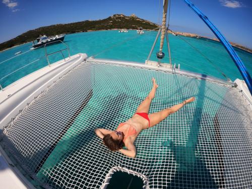 Girl lying on board a catamaran in the Archipelago of La Maddalena