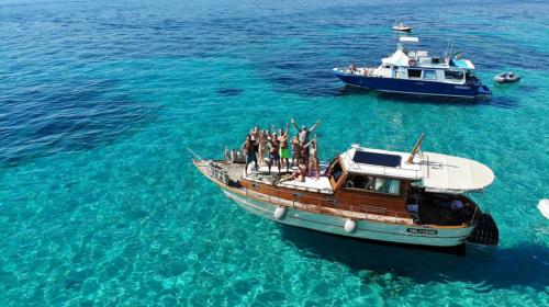 Barca con escursionisti naviga nell'Arcipelago di La Maddalena