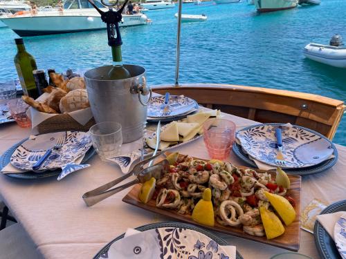 Pranzo abbondante con prodotti locali a bordo di una barca nell'Arcipelago di La Maddalena