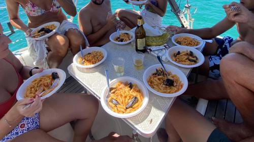 pasta with mussel sauce lunch on a sailing boat in Stintino