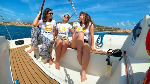 Three girls have fun aboard the sailing boat Equinoxe