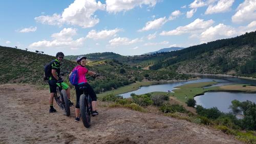 Two cyclists enjoy the view of the Flumendosa River