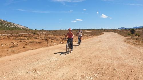 Two hikers cycle during an electric bike hike in Supramonte