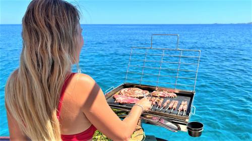 Barbecue prepared on board a yacht during a tour of Villasimius