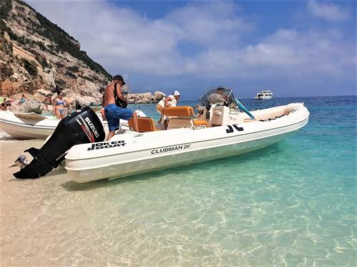 Inflatable boat with tourists during day tour in the Gulf of Orosei