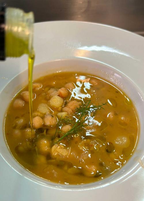 Oil poured into chickpea soup
