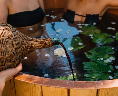 Wine poured into the tub where two girls are bathing