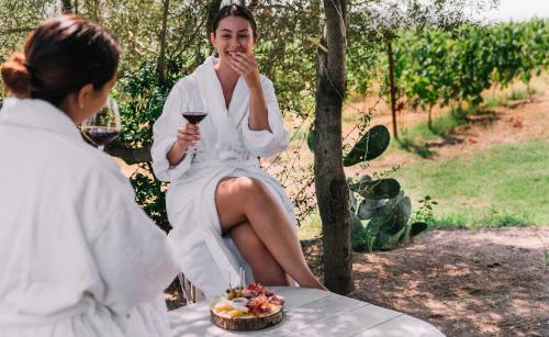 Zwei Mädchen entspannen sich im Weinberg und genießen lokale Produkte