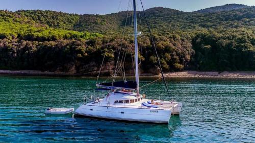 Catamaran in the crystal-clear waters of the islands of the La Maddalena Archipelago National Park