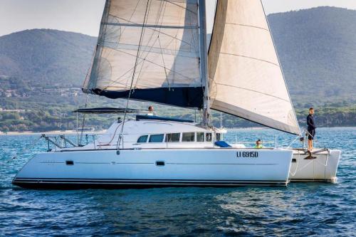 Catamaran in the crystal-clear waters of the islands of the La Maddalena Archipelago National Park