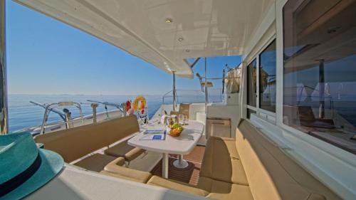 Catamaran lounge as it sails through the crystal-clear waters of Cape Ceraso