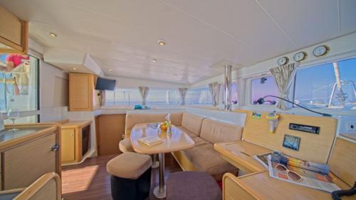 Lounge of the catamaran as it sails through the crystal-clear waters of Tavolara
