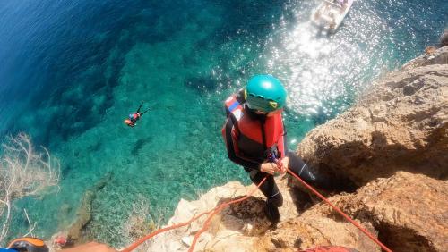 A girl rappels with a rope