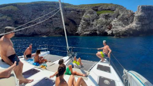 People relax on the bow of the catamaran