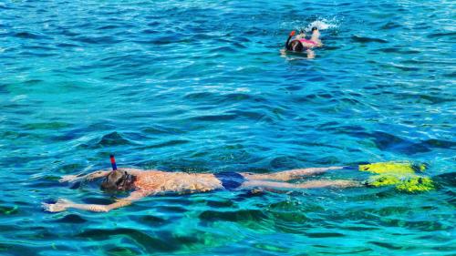 Two young boys snorkel in the Gulf of Orosei