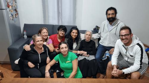 The guide and tour participants visiting the home of a local elderly woman