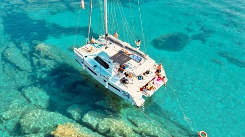 Catamaran in the crystal clear water of Asinara