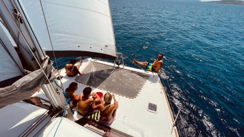 Hikers relax in the bow of the catamaran