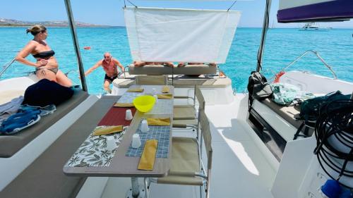 Hikers prepare for lunch aboard catamaran on Asinara island