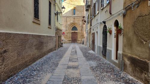 Street in the historic center of Alghero with a glimpse of the church