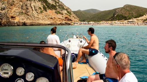 Hikers aboard the dinghy in Cala Domestica