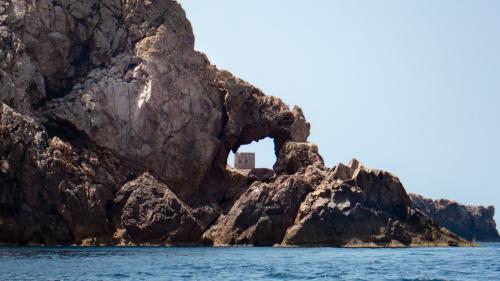 Glimpse into the coast of Buggerru with a view of the turret of Cala Domestica