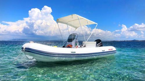 Inflatable boat with open awning in the waters of the Sulcis archipelago