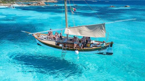 Vintage sailboat in the crystal clear water of Tavolara MPA