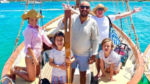 Commander and a family aboard the vintage sailboat