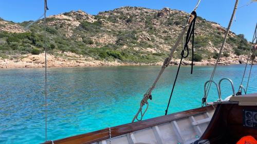 Barca a vela d'epoca sosta nell'acqua cristallina del mare dell'Area Marina Protetta di Tavolara