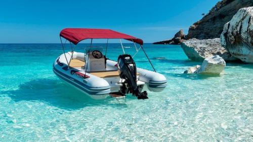 Inflatable boat stop in the crystal clear water of the Gulf of Orosei
