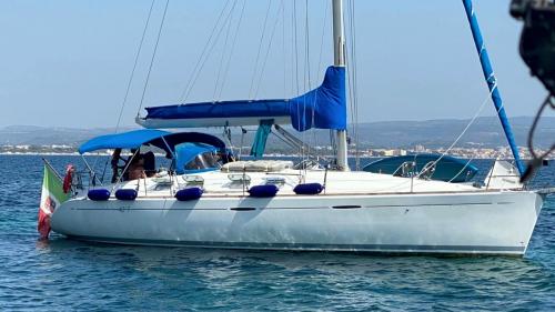 White sailboat in Alghero harbour