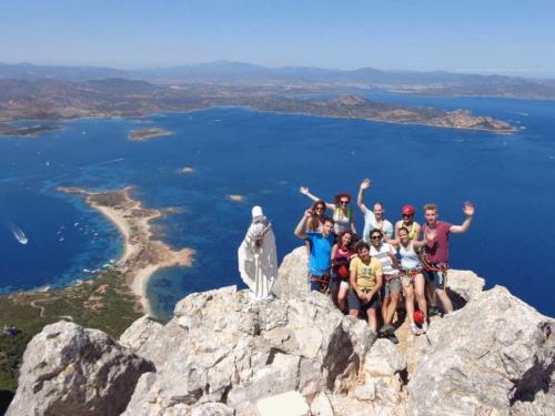 Group of hikers on the summit of Tavolara