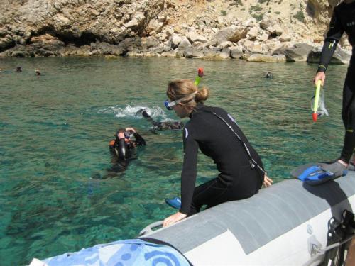 Girl ready to dive from the dinghy