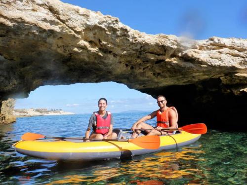 Couple in a double kayak between the coves of Balai