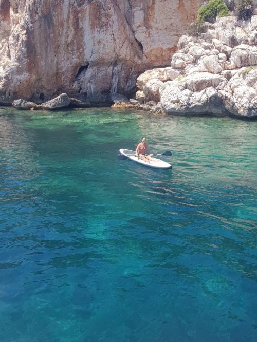 Girl in SUP on the coast of Alghero
