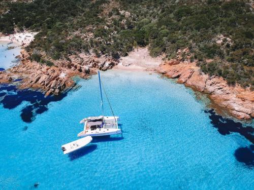 Catamaran and dinghy near the coast