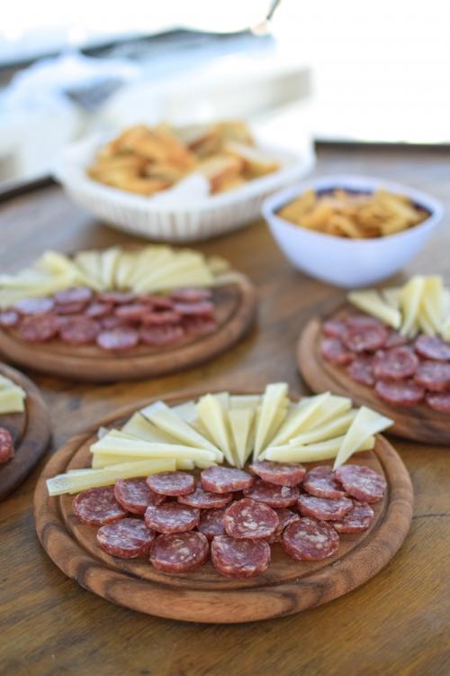 Aperitif with sausage and cheese on board a catamaran