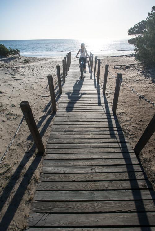 Hiker by bike during a guided tour on the beach in the territory of Orosei