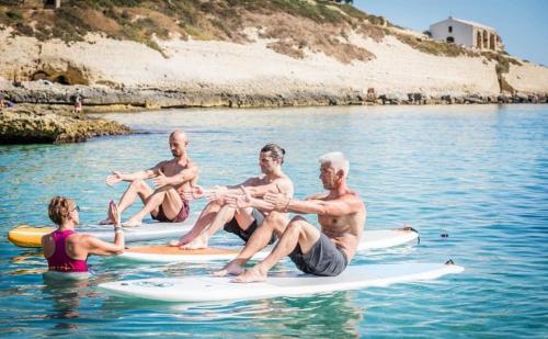 Boys on Sup during pilates class with instructor