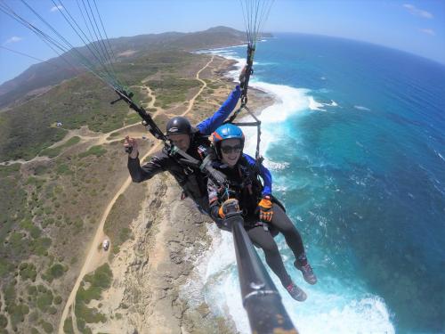 Paragliding flight with sea view