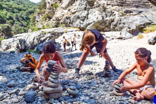 Children during a hike on the pebbles by sa stiddiosa