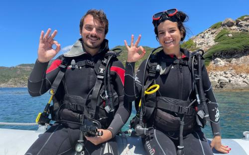 Happy excursionists during underwater baptism discovery diving
