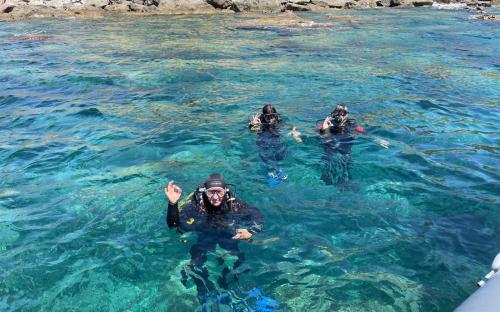 Hikers exploring the sea in Bosa during underwater baptism