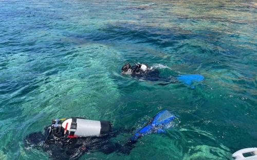 Hikers exploring the sea in Bosa during underwater baptism