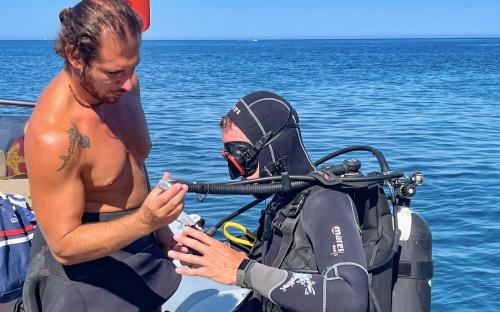 Hiker with guide during underwater baptism