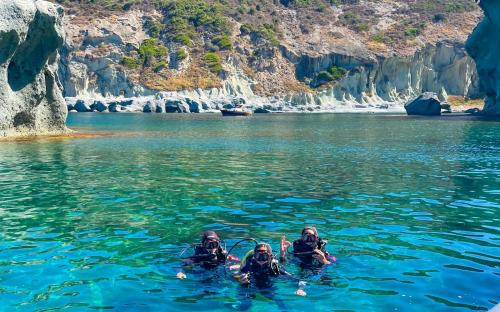 Hikers exploring the sea in Bosa during underwater baptism