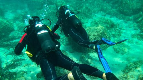 Hikers exploring the sea in Bosa during underwater baptism