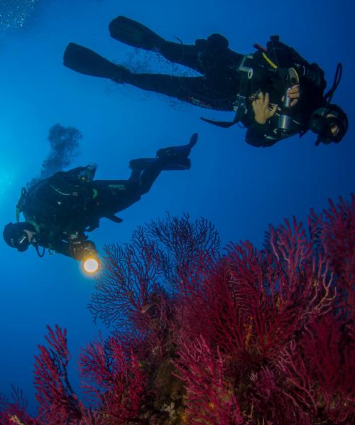 Hiker with guide during underwater baptism