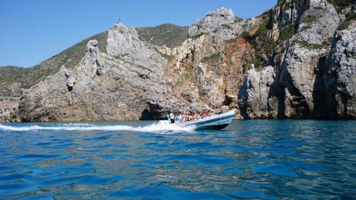 Guys in dinghy in the blue sea of Bugerru